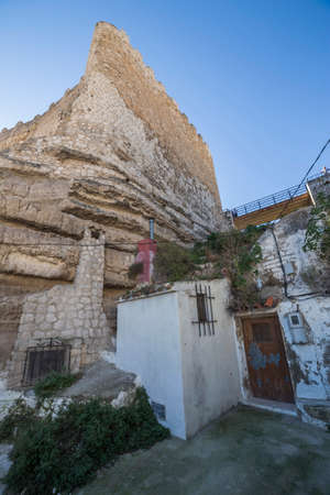 Alcala del Jucar, Spain - October 29, 2016: typical house of La Mancha placed in the skirts of the castle, on top of limestone mountain is situated Castle of the 12TH century Almohad origin, take in Alcala del Jucar, Albacete province, Spainのeditorial素材