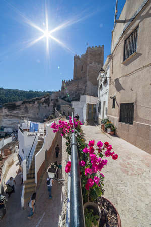 Alcala del Jucar, Spain - October 29, 2016: Side view of the village, on top of limestone mountain is situated Castle of the 12TH century Almohad origin, take in Alcala of the Jucar, Albacete province, Spainのeditorial素材