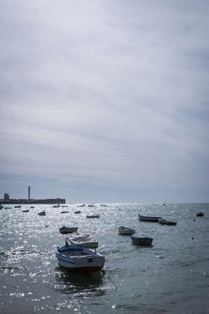 Caleta Beach and fishing boats in Cadiz, Spainの写真素材