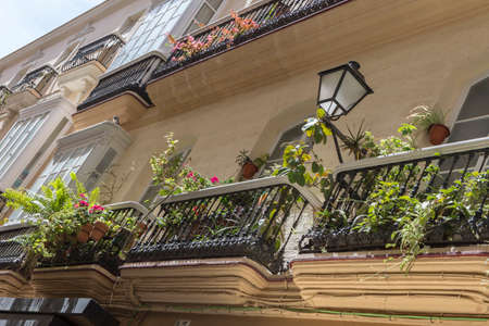 Cadiz Spain- March 31: Detail of balconies and large windows on the time of the nineteenth century, Narrow street with traditional architecture in Cadiz, Andalusia, southern Spainのeditorial素材