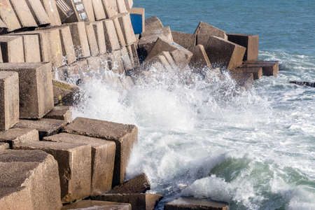Waves hit the rocks on the promenade of the La Caleta beach in Cadiz, Spainの写真素材