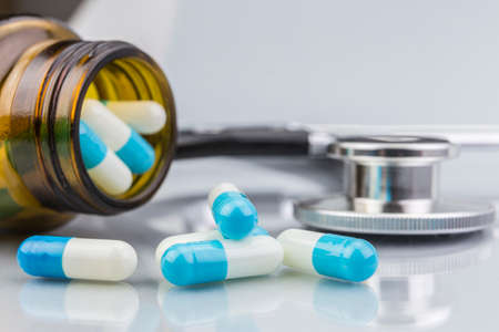 Blue and white pills, container transparentの写真素材