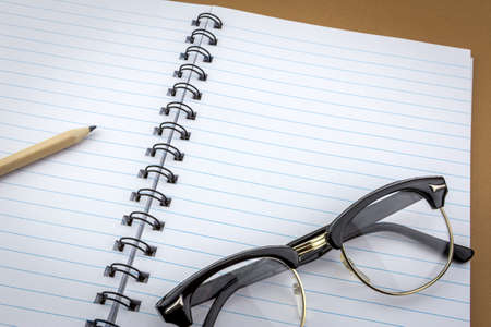 Vintage glasses old on a notebook of workの写真素材