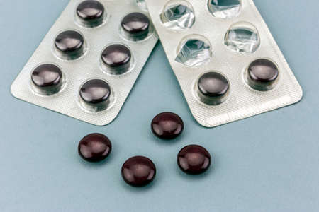 close up of medical pills isolated on blue backgroundの写真素材