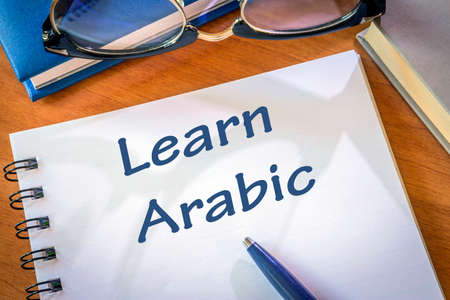 Learn arabic written in a notepad. Education conceptの写真素材