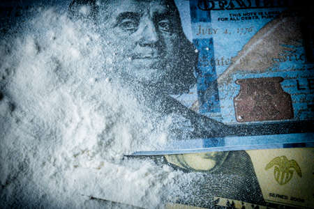 Cocaine drug powder pile along with several dollar ticketsの写真素材