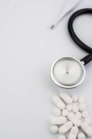 Health care concept. Pills, thermometer and stethoscope on white backgroundの写真素材