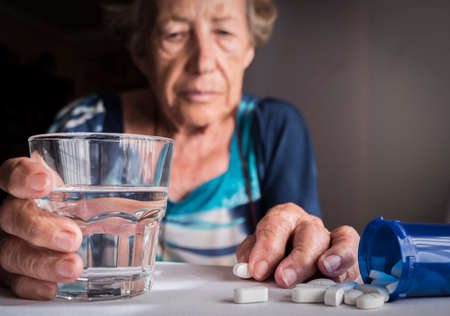 Oldster taking daily medication dose at home, Andalusia, Spainの写真素材