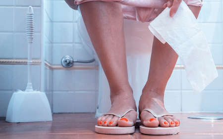 Woman sat in the toiletの写真素材