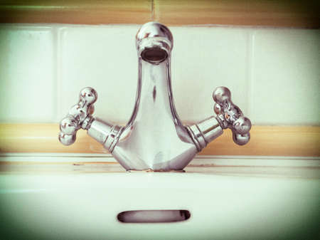 ancient faucet in bathroomの写真素材