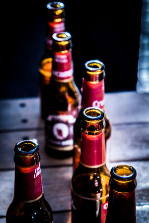 Beer bottles on a table, conceptual imageの写真素材