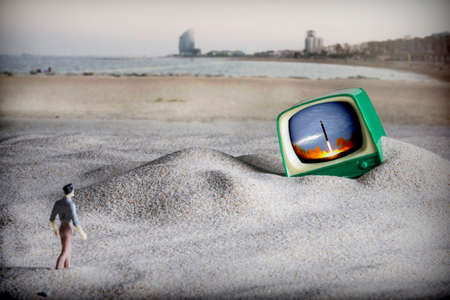 Dramatization of the end of the world, a man walks to an old television on the beach in Barcelona, North Korea has just launched a ballistic missile to Europeの写真素材
