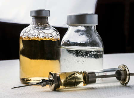 Several vials and syringe in laboratory, conceptual imageの写真素材