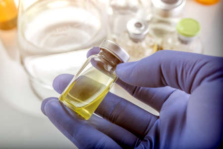 Detail Of Hand Medical Holding A Vial, Conceptual Image