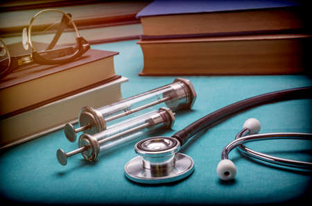 Medicine Books Next To Syringes Vintage And Stethoscope, Concept Of Medicineの写真素材