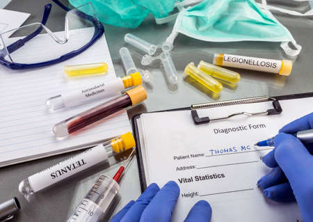 Doctor by filling in form of samples of contagious diseases in a laboratory, clinicalの写真素材