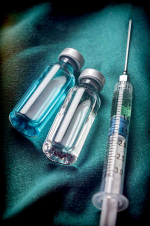 Some Vials And Syringe On Operating Table