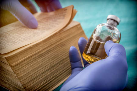 Doctor reading book of old medicine, conceptual imageの写真素材