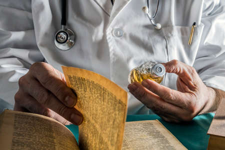 Doctor reading book of old medicine, conceptual imageの写真素材