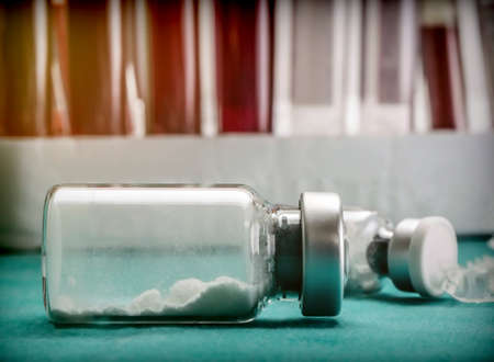 Glass vial glass contains medication powder to be diluted with serum in a laboratoryの写真素材