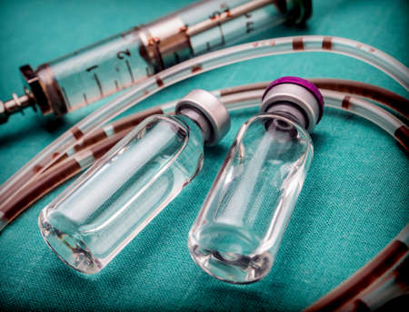 Rubber drip irrigation system with traces of blood along with vial, conceptual imageの写真素材