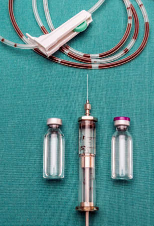Drip irrigation system with traces of blood along with vials and vintage syringe, conceptual imageの写真素材