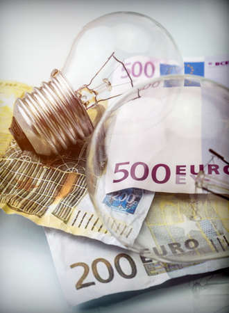 A lightbulb on euro bill, energy saving concept