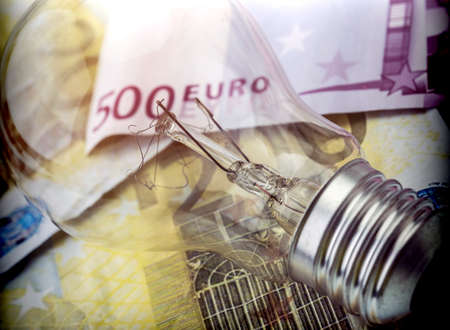 A lightbulb on euro bill, energy saving conceptの写真素材