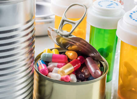 Tin metal contains white pills and red, conceptual imageの写真素材