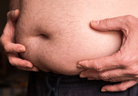 Man with overweight touching the belly, image coceptualの写真素材