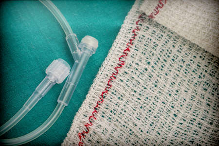 Gauze next to tubes of irrigation in an operating theaterの写真素材