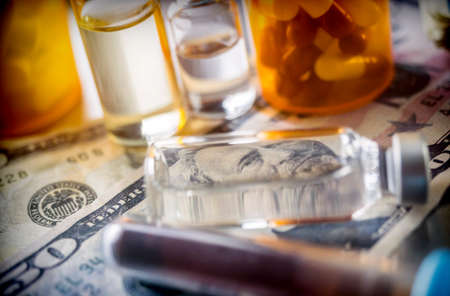 vials with different substances over dollar, concept of copayment