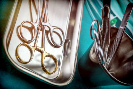Some scissors for surgery on a tray in an operating theater, conceptual image