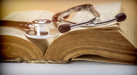 Stethoscope on an old book of medicine, conceptual imageの写真素材