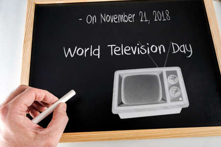 On November 21, 2018 world day of the television written to hand with chalk on a slate, conceptual imageの写真素材
