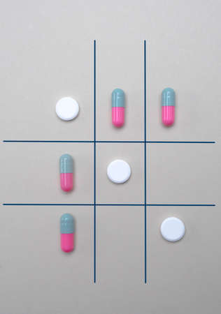 Game of the three in a row with tablets and capsules, conceptual image
