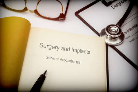 Titled book Surgery and implants general procedures along with medical equipment, conceptual image