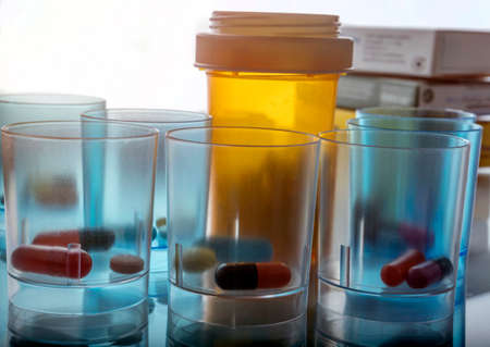 Several plastic glasses with daily medication in hospital, conceptual imageの写真素材