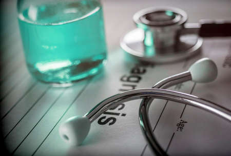 Vial of medication along with a stethoscope, conceptual image