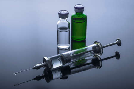 Vintage syringe with vials, conceptual imageの写真素材