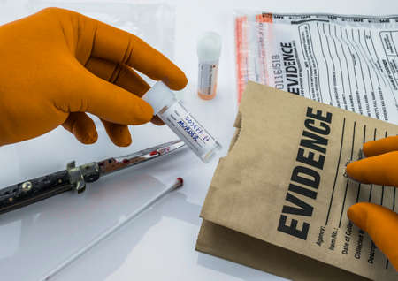Crime scene for cutting weapon, Judicial police takes blood samples in evidence bag, conceptual...