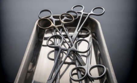 Some scissors for surgery on a tray, conceptual image, horizontal composition