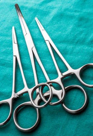 Some scissors for surgery in an operating theater, conceptual image, horizontal composition