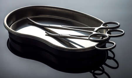 Some scissors for surgery on a tray, conceptual image, horizontal composition
