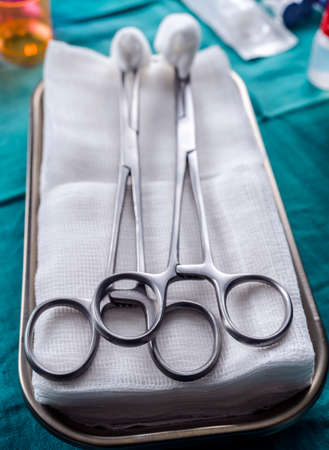 Scissors surgical with torundas on a tray metal in an operating theater, conceptual imageの写真素材