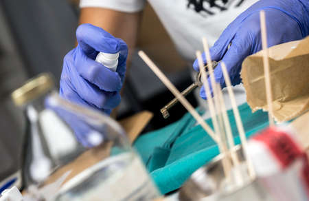 Police specialist examines key of a crime scene, conceptual image
