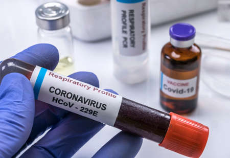 Scientist holds Codvid-19 coronavirus vaccine in hospital , conceptual imageの写真素材