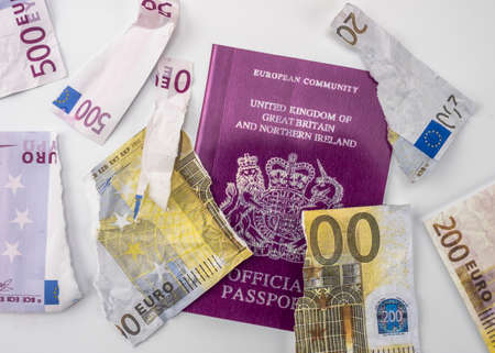 British passport next to broken euro notes, european union, brexit