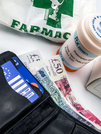 Medicines next to a wallet with British currency, european union, brexitの写真素材