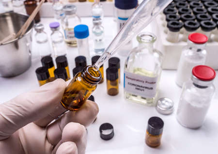 Scientist takes samples from a patient infected by Codvid-19 coronavirus in the laboratory,...